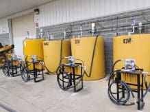 A group of yellow tanks sitting next to each other.