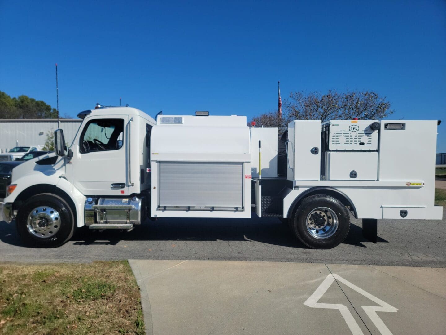 A white truck parked on the side of a road.