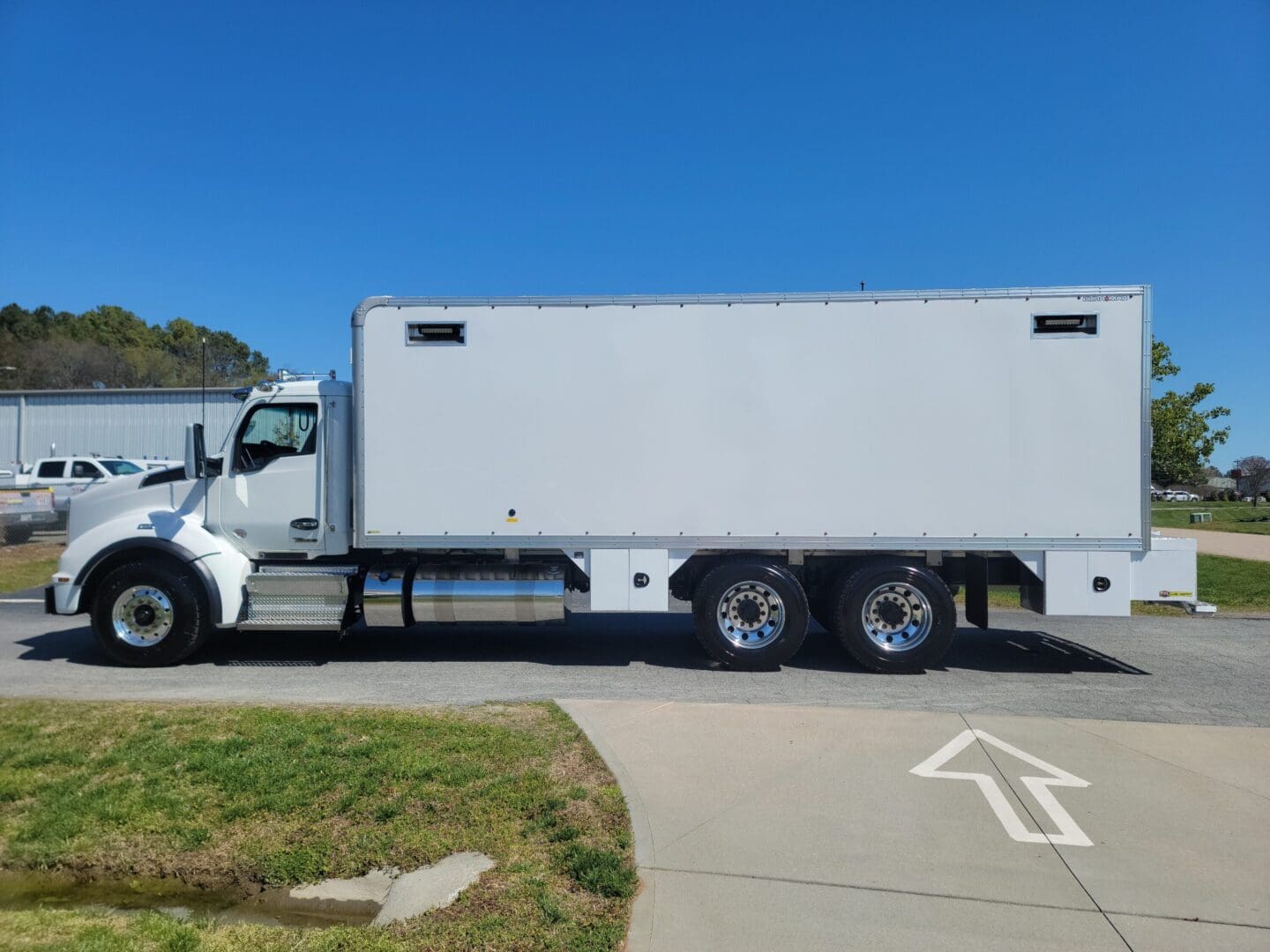 A large white truck parked on the side of a road.