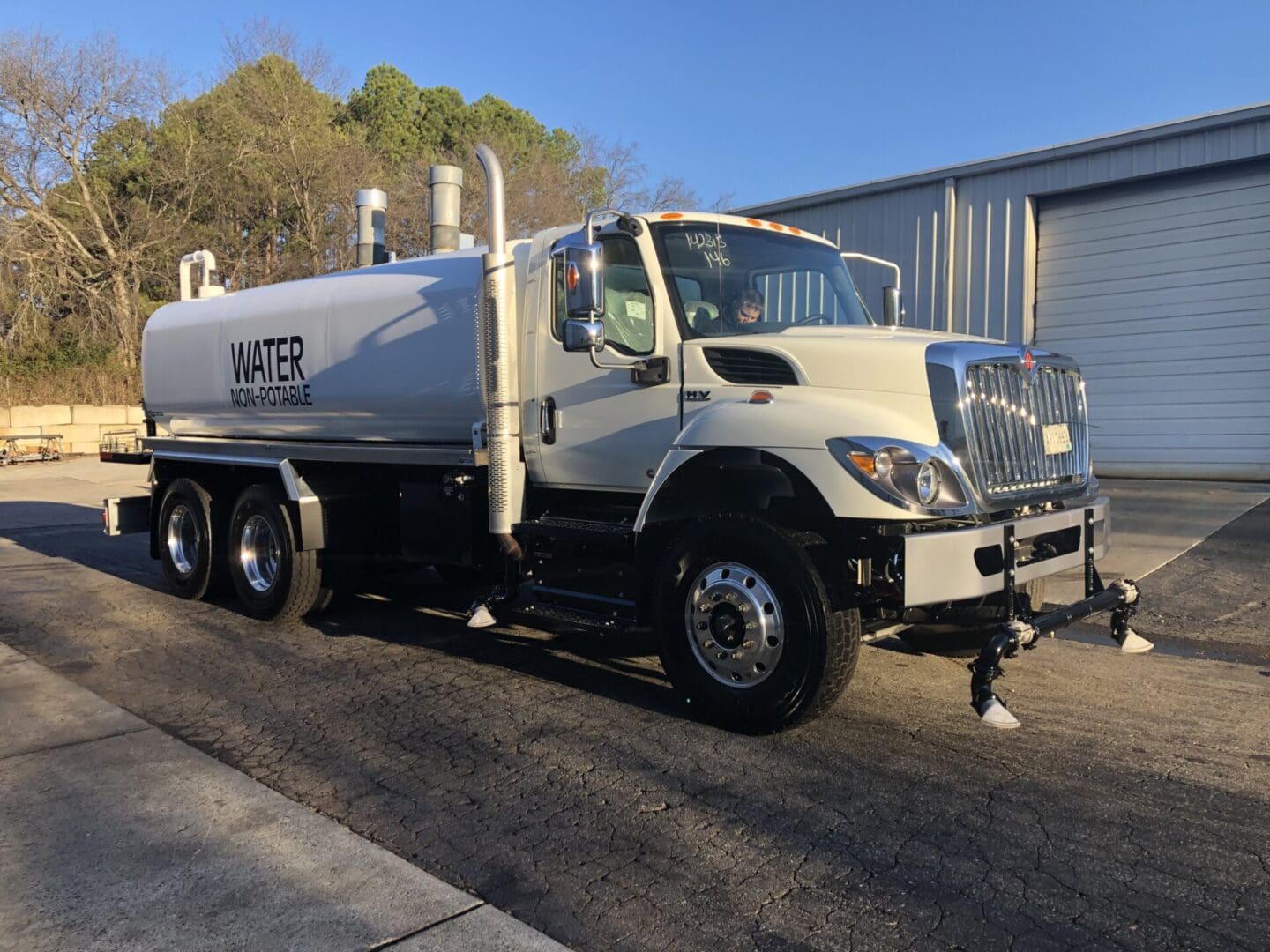 A white truck is parked in the street