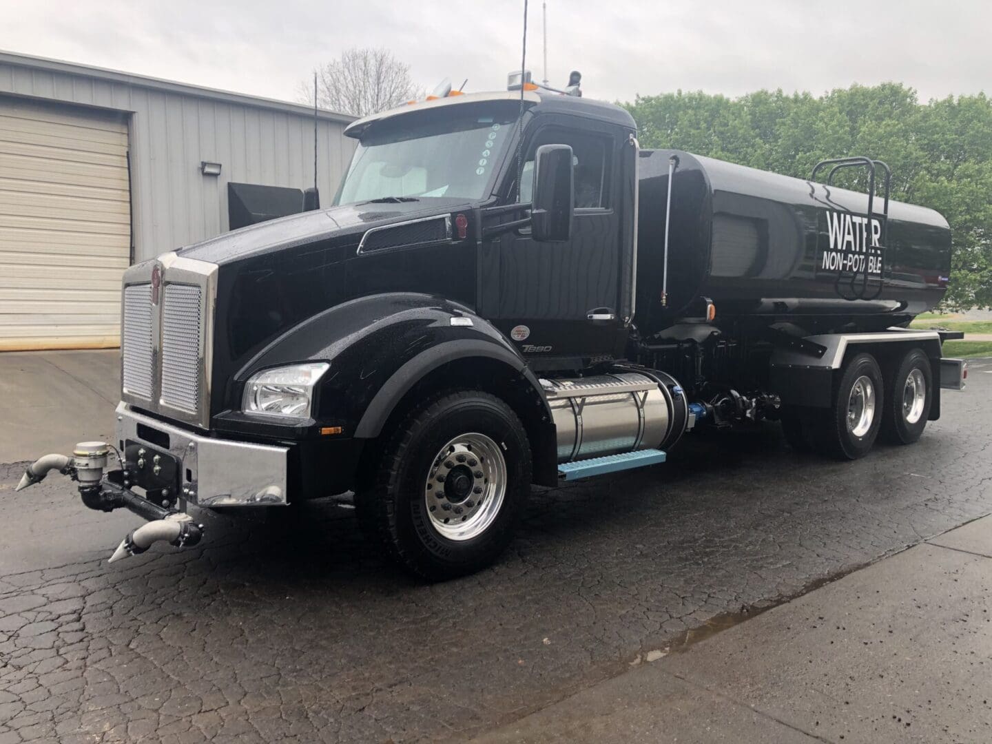 Black water truck with white lettering.