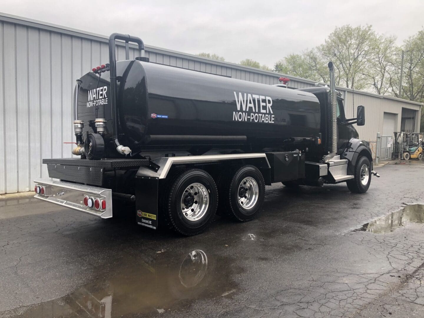 A black truck is parked on the side of the road.