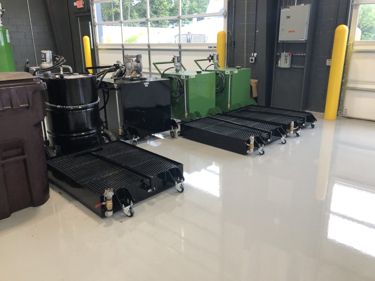 A room with several carts and bins on the floor.